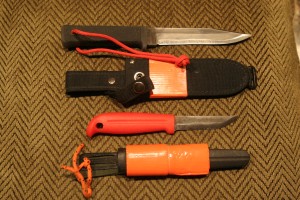 The Cold Steel SRK (top) and the J. Martinni Mora-style knives are good choices for all around use. Combined with a Swiss Army Classic, they can provide a good survival tool kit.