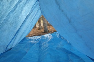 Place a smaller tarp or poncho inside the A-Frame, with the edges raised. This will provide a dry sleeping area, and will keep water from draining downhill onto your gear.