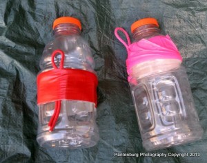 These quart electrolyte drink plastic bottles can make servicable canteens when some paracord and duct tape are used. They are easily carried on a belt clip. 