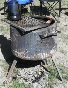 This dryer basket was improved with legs, handles and a grill. Total cost of the unit is still dirt cheap!