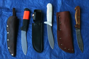 These three different models of lamb skinner knives all have different styles of sheaths. The wooden-handled knife gets the most use.