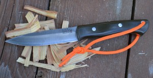 This Bark River Aurora will be easier to see with the fluorescent, reflective paracord attached to the handle.