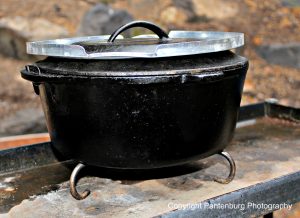 A pie crust saver and trivet can convert an indoor oven into an outdoor baker.